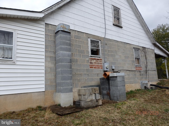 view of property exterior with concrete block siding