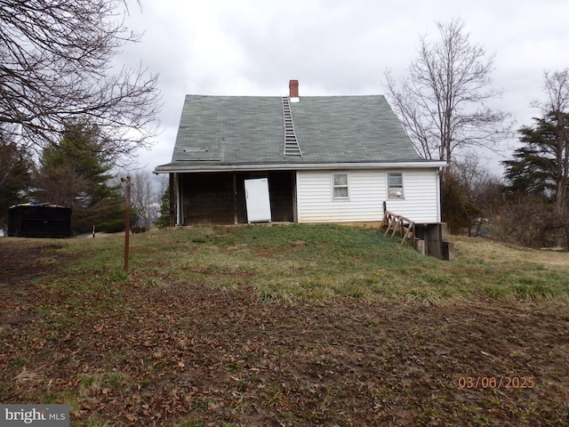 back of property with a chimney