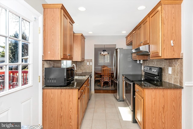 kitchen featuring light tile patterned floors, a sink, stainless steel range with electric stovetop, under cabinet range hood, and black microwave