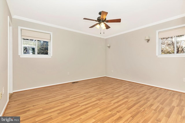 unfurnished room featuring crown molding, a healthy amount of sunlight, and light wood-type flooring