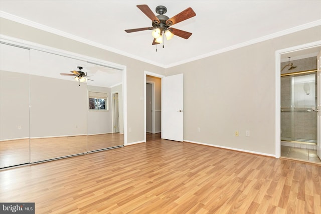 unfurnished bedroom featuring baseboards, light wood finished floors, ensuite bath, ceiling fan, and ornamental molding