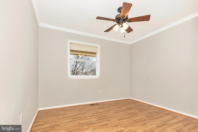 unfurnished room with visible vents, baseboards, ceiling fan, light wood-style floors, and crown molding