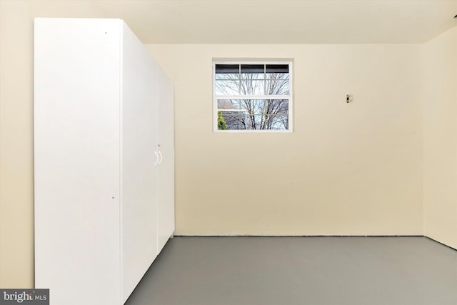 unfurnished room with finished concrete floors