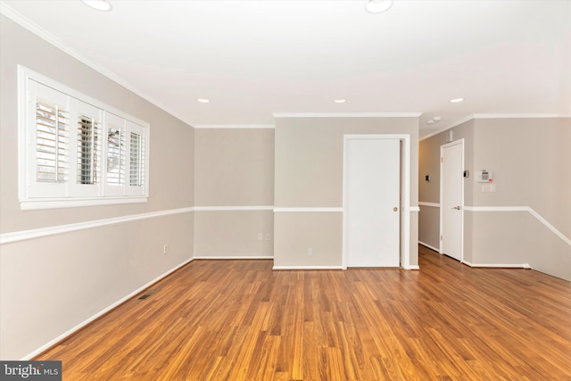 spare room featuring recessed lighting, crown molding, and wood finished floors