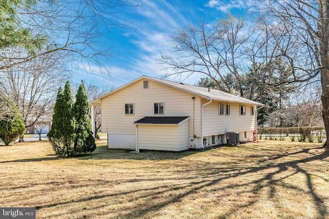 view of property exterior with a yard and cooling unit