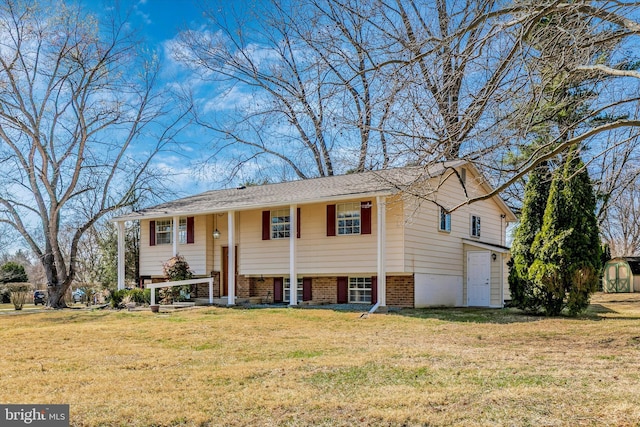 raised ranch featuring brick siding, an outbuilding, a storage shed, and a front lawn