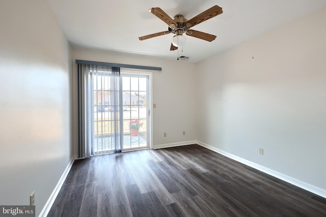 unfurnished room featuring a ceiling fan, dark wood finished floors, visible vents, and baseboards