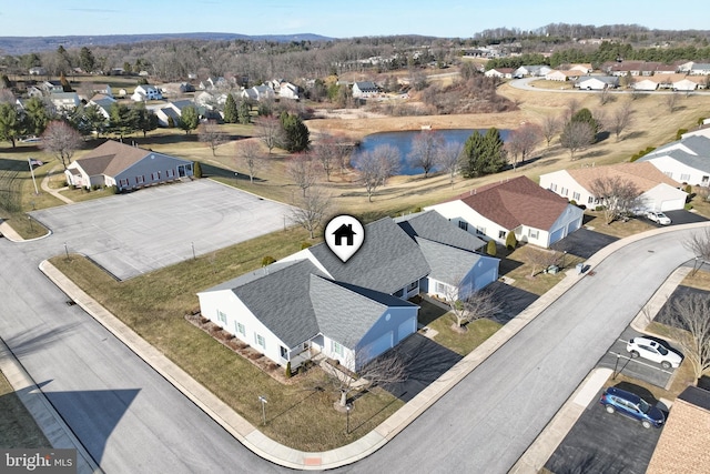 birds eye view of property with a water view and a residential view