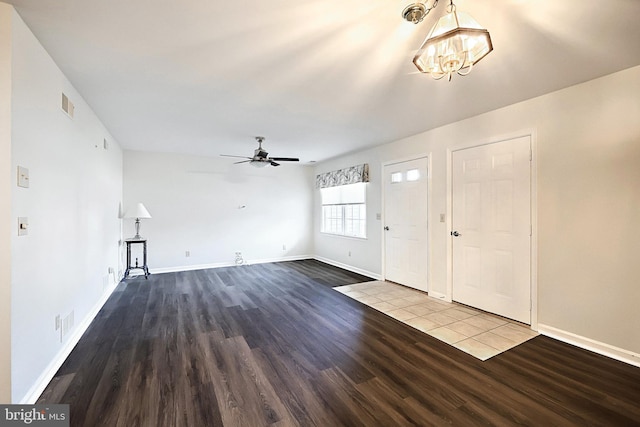 entrance foyer with ceiling fan with notable chandelier, wood finished floors, visible vents, and baseboards