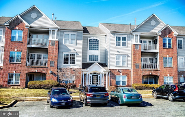 view of building exterior featuring uncovered parking