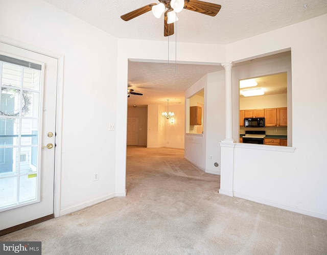 spare room with baseboards, light carpet, ceiling fan with notable chandelier, a textured ceiling, and ornate columns