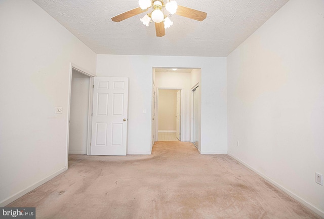 unfurnished bedroom featuring carpet flooring, baseboards, and a textured ceiling