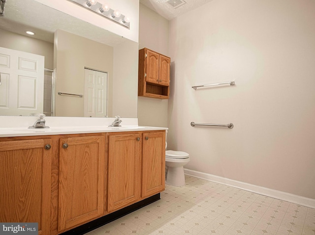 bathroom with tile patterned floors, double vanity, baseboards, and a sink