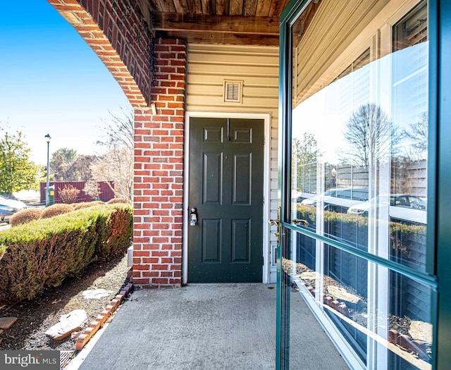 property entrance with brick siding