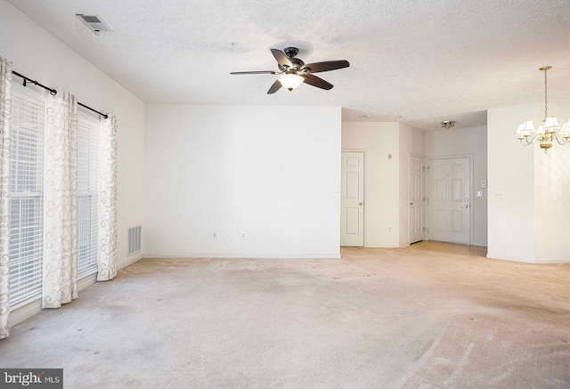 unfurnished room featuring visible vents, light carpet, and a textured ceiling