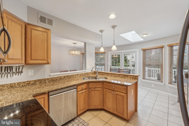 kitchen featuring light stone counters, a peninsula, a sink, visible vents, and stainless steel dishwasher