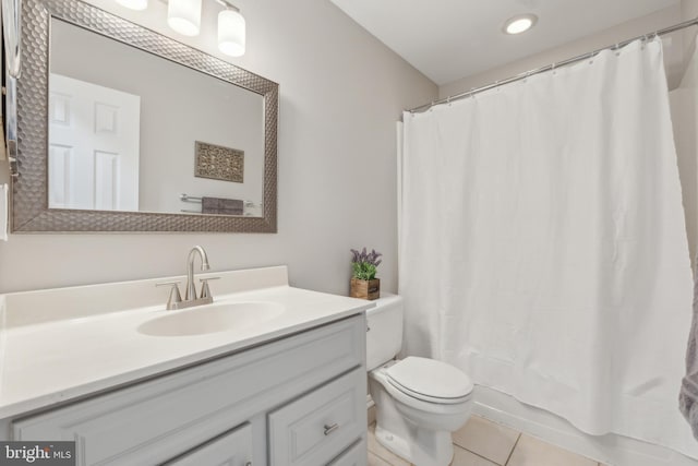 bathroom featuring shower / tub combo, tile patterned flooring, vanity, and toilet