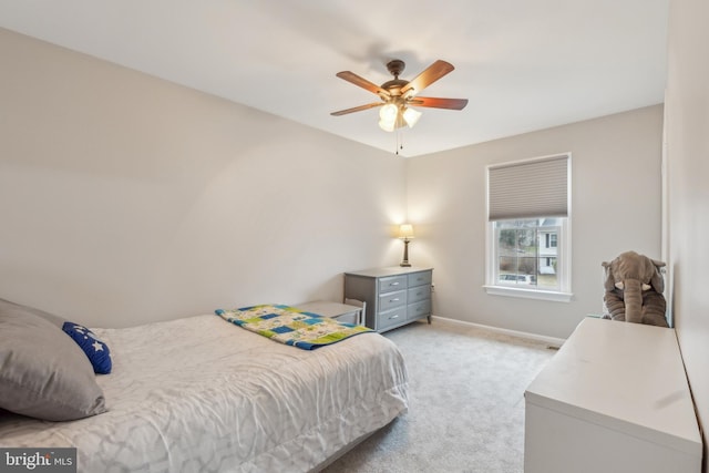 bedroom with light colored carpet, ceiling fan, and baseboards