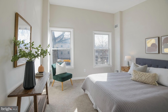 carpeted bedroom featuring visible vents and baseboards