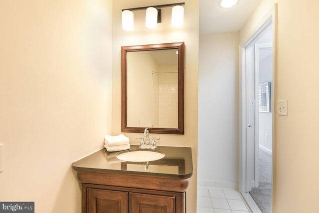 bathroom featuring tile patterned flooring, baseboards, and vanity