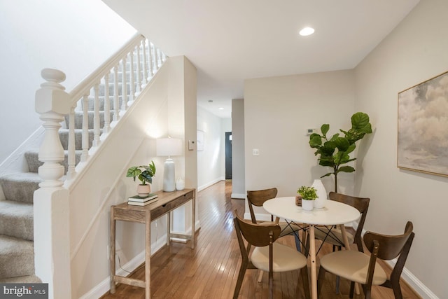 dining space with recessed lighting, stairway, baseboards, and hardwood / wood-style flooring