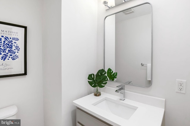 bathroom featuring toilet and vanity