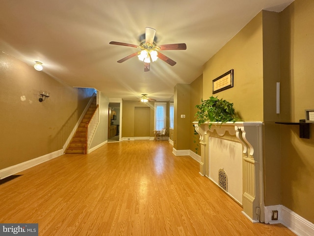 unfurnished living room featuring baseboards, ceiling fan, visible vents, and light wood finished floors