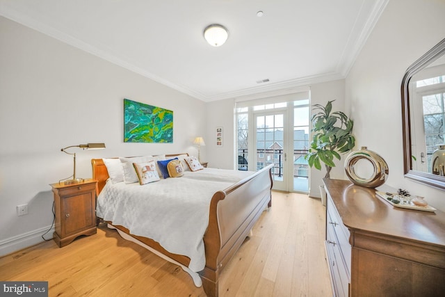 bedroom with access to exterior, multiple windows, ornamental molding, and light wood finished floors