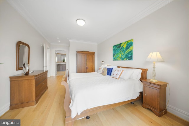 bedroom with light wood-style flooring, baseboards, and crown molding