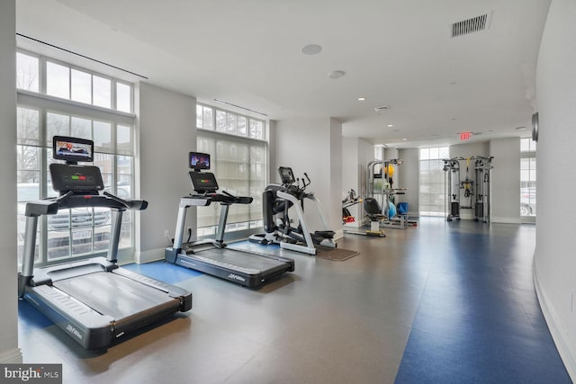 exercise room with a wealth of natural light, visible vents, and baseboards