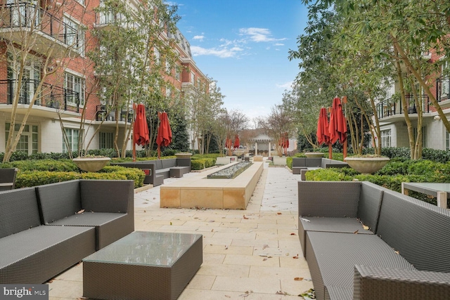 surrounding community featuring outdoor lounge area and a patio