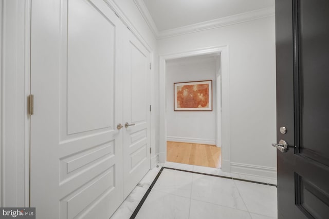 interior space featuring crown molding and baseboards