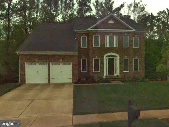 view of front of property with concrete driveway and a front lawn