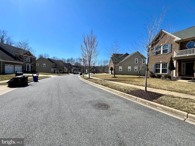 view of street featuring a residential view, curbs, and sidewalks