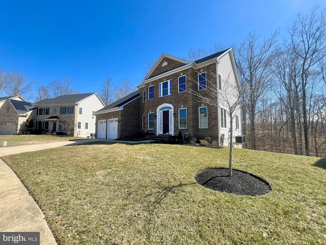 view of front of home featuring an attached garage, a front lawn, concrete driveway, and brick siding