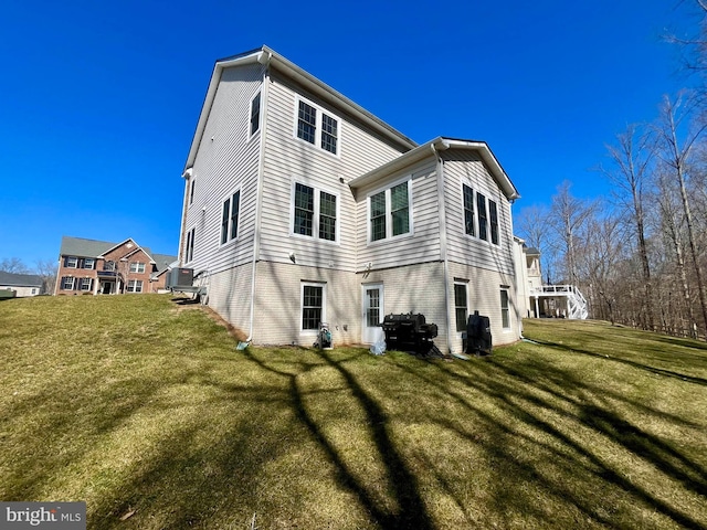 rear view of house featuring a lawn