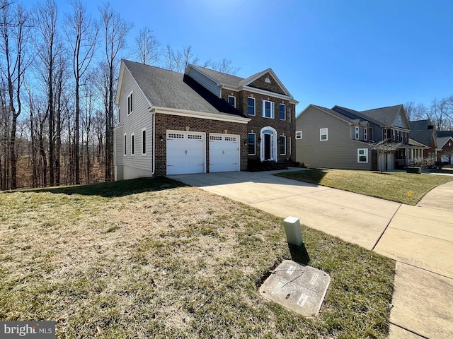 view of front of home with an attached garage, driveway, a front lawn, and brick siding