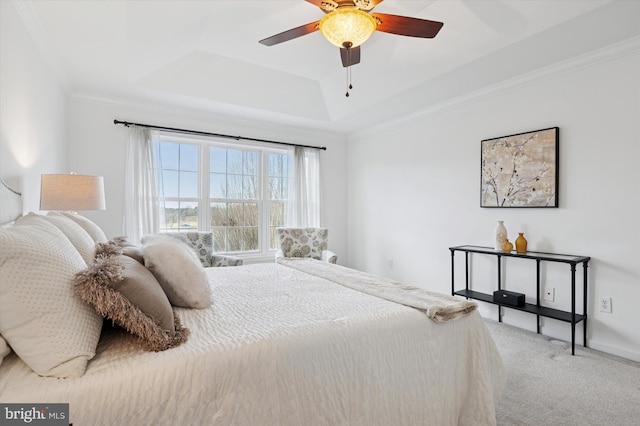 bedroom featuring carpet flooring, a ceiling fan, baseboards, a tray ceiling, and crown molding