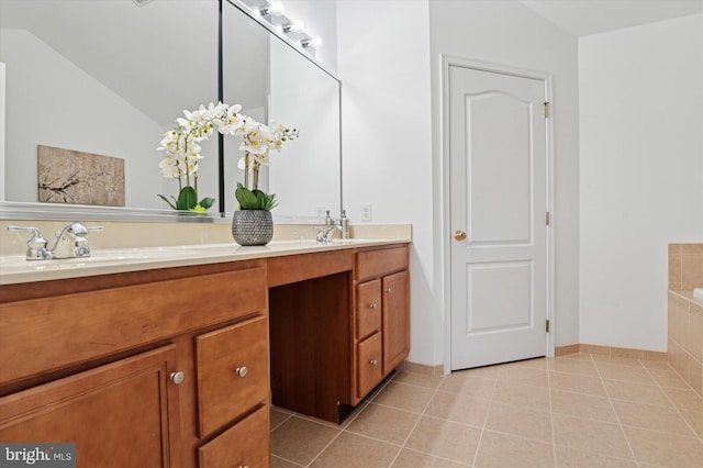 bathroom featuring double vanity, tiled bath, vaulted ceiling, a sink, and tile patterned flooring