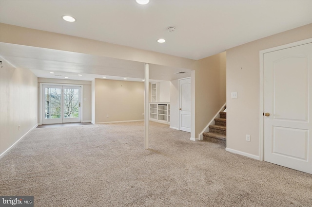 below grade area featuring stairs, carpet floors, recessed lighting, and baseboards