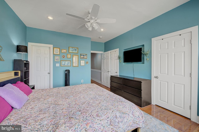 bedroom featuring ceiling fan, wood finished floors, and recessed lighting