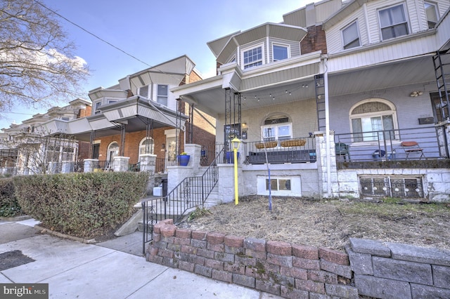 multi unit property with covered porch and brick siding