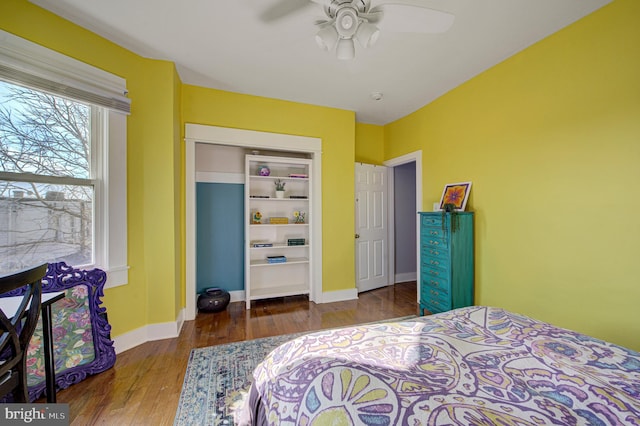 bedroom featuring ceiling fan, wood finished floors, and baseboards