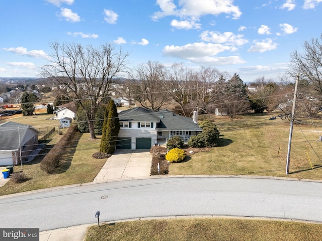 view of front of property with concrete driveway and a front yard