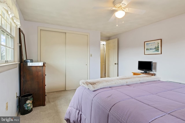 carpeted bedroom with a closet and a ceiling fan