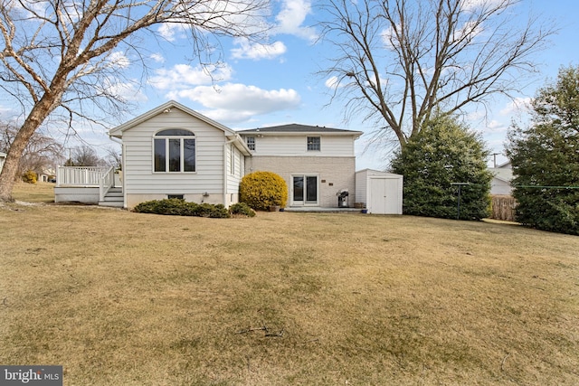 back of property featuring a storage shed, a lawn, and an outbuilding