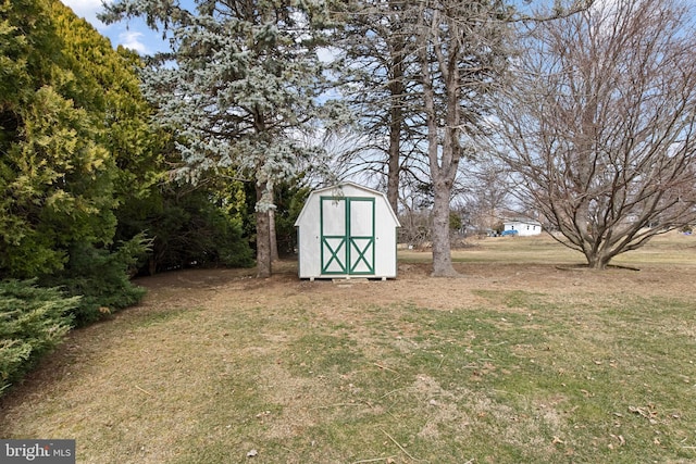 view of yard featuring a storage shed and an outbuilding