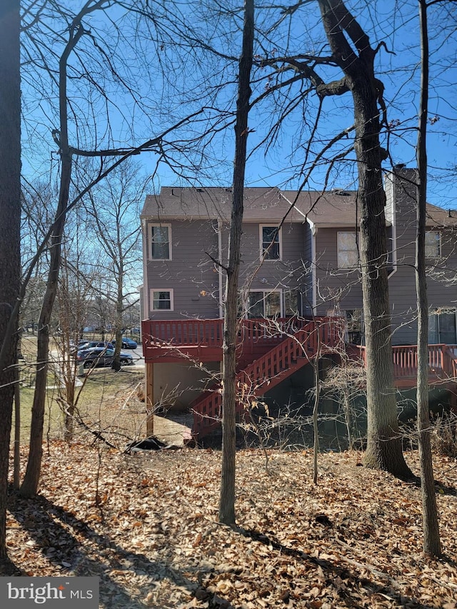 rear view of house with a deck and stairway