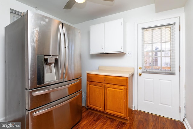 kitchen with dark wood-type flooring, white cabinets, light countertops, stainless steel refrigerator with ice dispenser, and brown cabinets