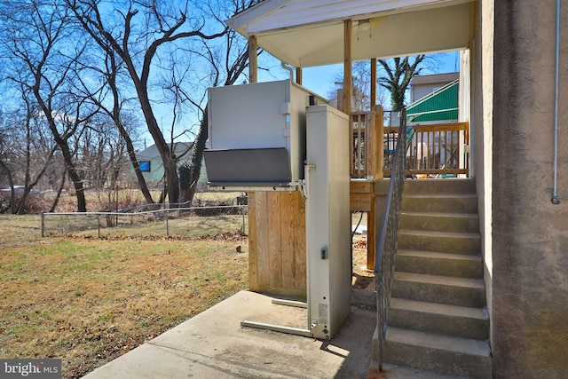 details featuring fence and stucco siding